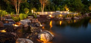 Outdoor lighting design around a beautiful pond with rocks by Superior Garden Center in Columbia, MIssouri