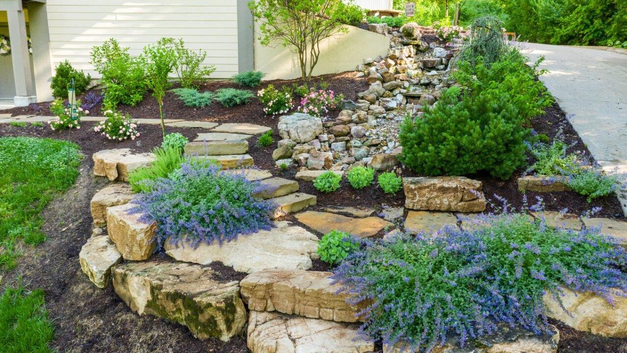 stone steips with landscaped beds with bushes and flowers