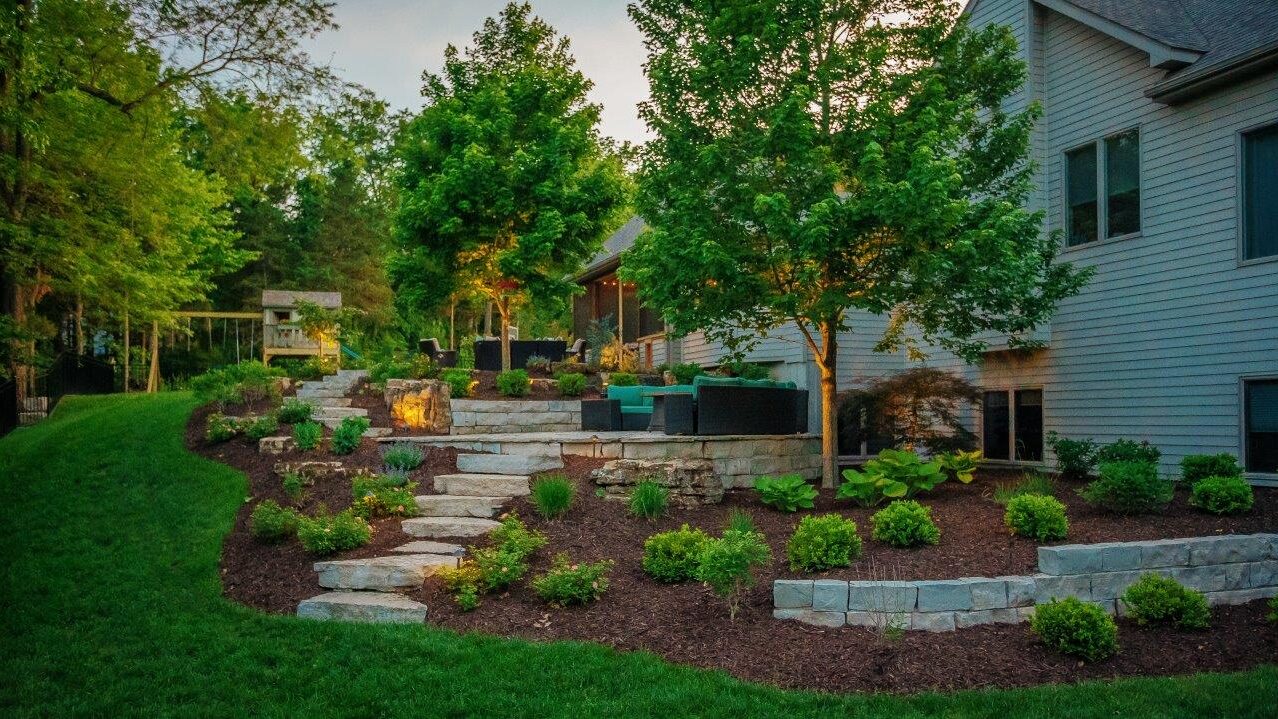 stone steps and landings with multiple seating areas and landscaping on side of hill next to house