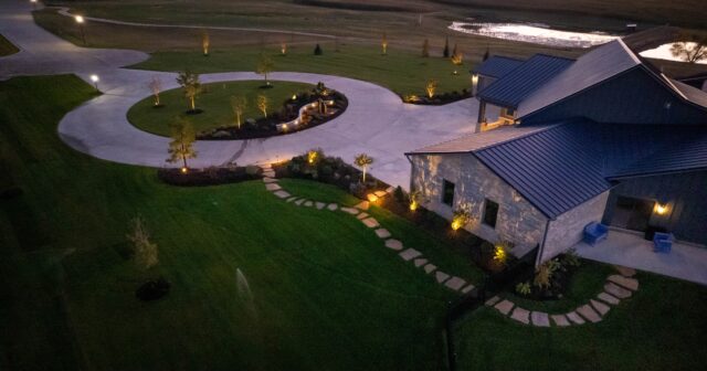 aerial view of circle drive and flagstone walkway at a house during sunset